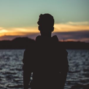 Silhouette Photo of Person Near Body of Water